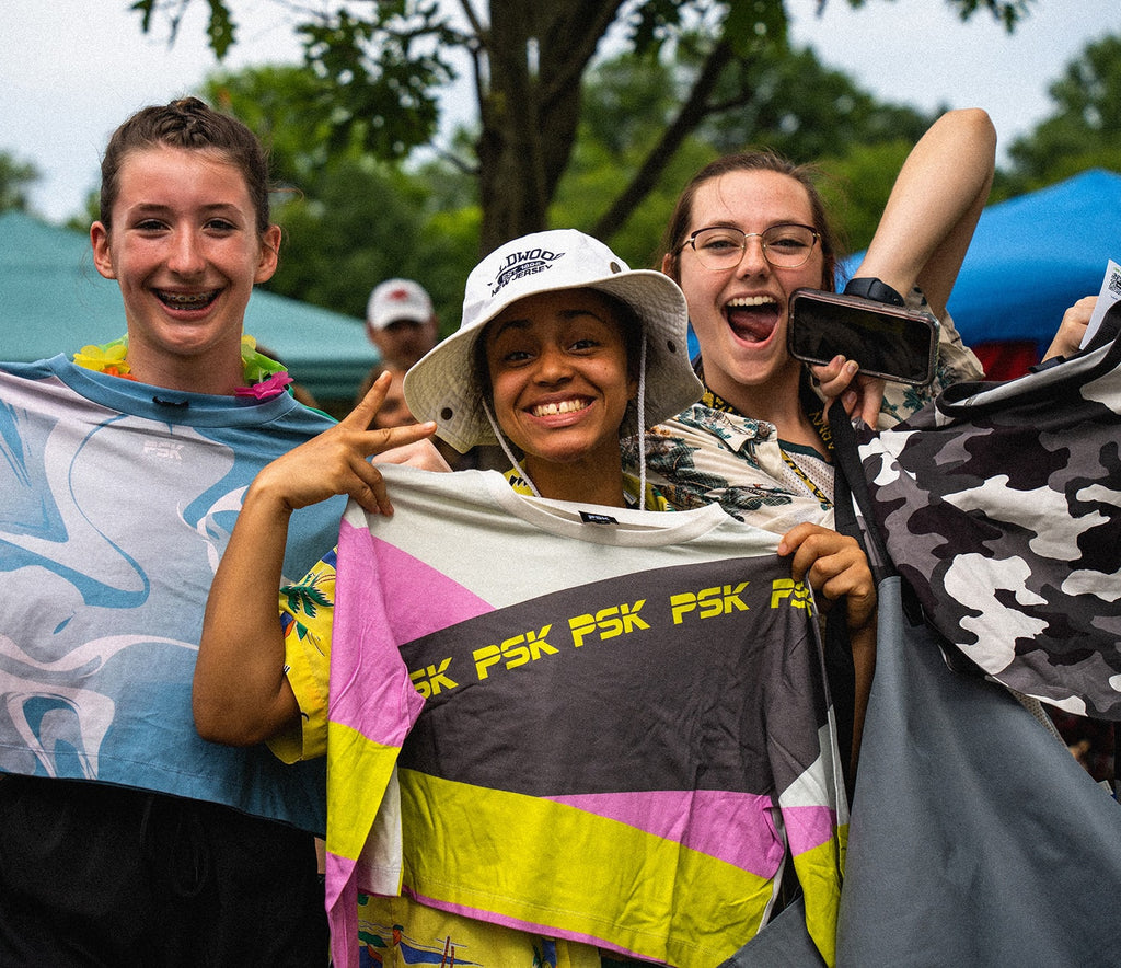 Diverse group of young women holding free shirts from PSK Collective