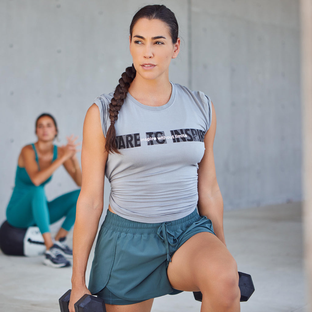 Woman exercising wearing PSK Collective grey Dare to Inspire Tee